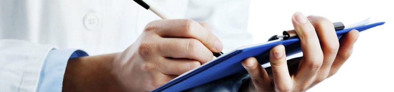 Doctor writing down a mesothelioma treatment plan.