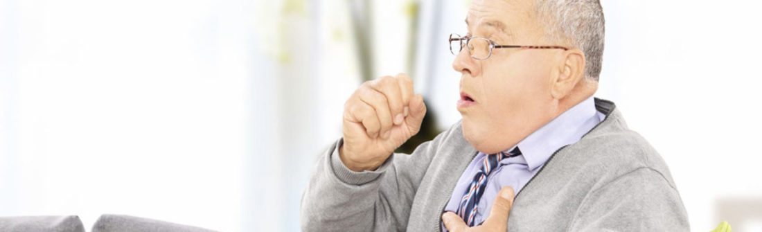 Man showing mesothelioma symptoms as he coughs.